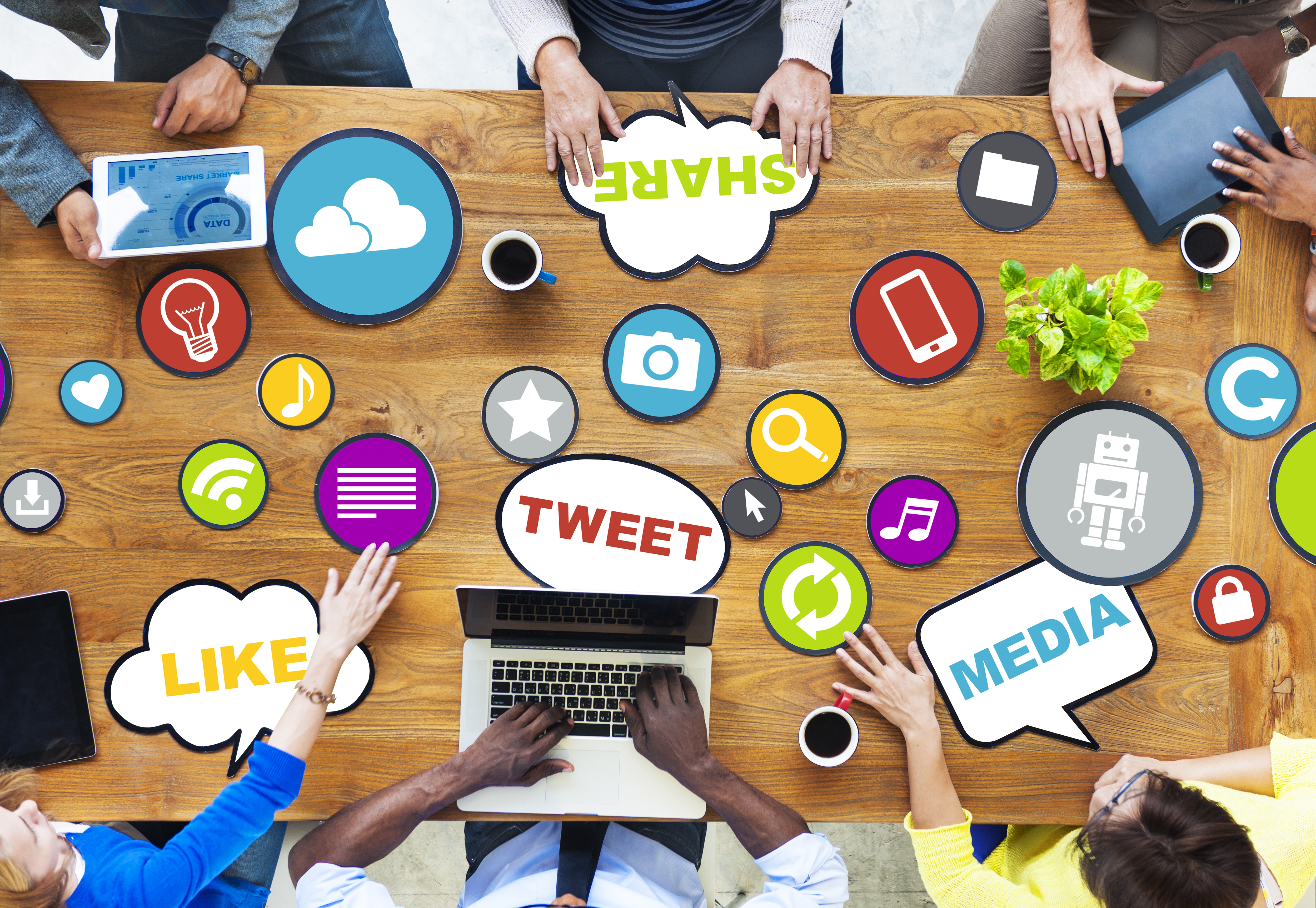 picutre of people surrounding a table full of media related icons